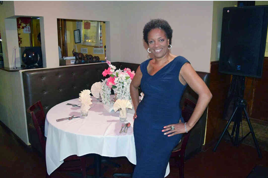 Movie producer Marcia Deans standing by a decorated table